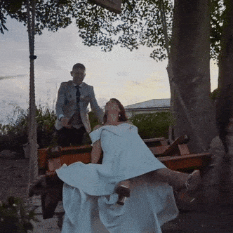 Couple relaxing on a swing at dusk